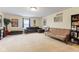 Spacious living area with a large sectional couch, futon, and bookshelves, offering ample seating and storage at 11130 Sanabria Dr, Indianapolis, IN 46235