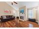 Bright living room featuring wood floors, a fireplace, and vaulted ceiling at 11130 Sanabria Dr, Indianapolis, IN 46235