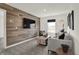 Cozy living room boasts a modern couch, accent wall, and mounted television at 11730 Cotterill Way, Indianapolis, IN 46235