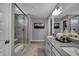 Modern bathroom with a glass-enclosed shower, double vanity, and stylish tile work creates a spa-like retreat at 1265 Sika Ln, Greenwood, IN 46143