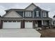 Charming two-story home with a brick and blue siding, complemented by a well-manicured lawn at 1265 Sika Ln, Greenwood, IN 46143