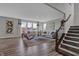 Spacious living room with hardwood floors, modern furniture, and bright windows at 1265 Sika Ln, Greenwood, IN 46143