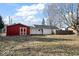 Spacious backyard featuring a charming red shed, white fencing, and ample open space at 1408 W Banta Rd, Indianapolis, IN 46217
