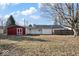 Spacious backyard featuring a charming red shed, white fencing, and ample open space at 1408 W Banta Rd, Indianapolis, IN 46217