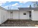 A view of the back exterior with white siding featuring two entrances at 1408 W Banta Rd, Indianapolis, IN 46217