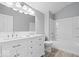 Bright bathroom featuring a double vanity, new hardware, and a shower and tub combo at 1408 W Banta Rd, Indianapolis, IN 46217