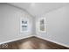 Bedroom with hardwood floors and two windows letting in natural light at 1408 W Banta Rd, Indianapolis, IN 46217