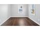Bedroom with a window view and hardwood flooring in a freshly painted space at 1408 W Banta Rd, Indianapolis, IN 46217