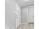 Bright entryway featuring white doors, light grey walls, and plank flooring at 1408 W Banta Rd, Indianapolis, IN 46217