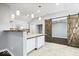 Well-lit kitchen with white cabinets, stylish backsplash, and modern countertops at 1408 W Banta Rd, Indianapolis, IN 46217