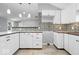 Well-lit kitchen with white cabinets, stylish backsplash, and modern countertops at 1408 W Banta Rd, Indianapolis, IN 46217