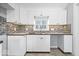Bright kitchen with white cabinetry, stainless steel sink and faucet with window at 1408 W Banta Rd, Indianapolis, IN 46217