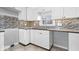 Well lit kitchen featuring white cabinets, tile backsplash, and dark wood countertops at 1408 W Banta Rd, Indianapolis, IN 46217