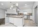 Modern kitchen featuring white cabinets, stone countertops, and stylish backsplash at 1408 W Banta Rd, Indianapolis, IN 46217