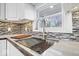 Close up view of the sink with a stainless steel drying rack and cutting board at 1408 W Banta Rd, Indianapolis, IN 46217
