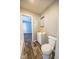 A standard bathroom with a tub, toilet, wood look flooring, and vanity sink at 1421 Shepard St, Indianapolis, IN 46221