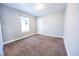 A neutral bedroom with wall to wall carpet, one window, and closet door at 1421 Shepard St, Indianapolis, IN 46221