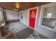 Inviting covered front porch featuring a classic red door, offering a warm welcome at 1421 Shepard St, Indianapolis, IN 46221