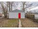 A detached single car garage with red door and a path to the garage at 1421 Shepard St, Indianapolis, IN 46221
