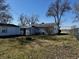 Spacious backyard featuring a shed, mature trees, fire pit, and a partial view of the surrounding neighborhood at 143 Sawmill Rd, Whiteland, IN 46184