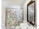 Full bathroom featuring a floral shower curtain and a framed mirror at 143 Sawmill Rd, Whiteland, IN 46184