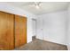 Bright bedroom features neutral carpet, a ceiling fan, and a closet with sliding wooden doors at 143 Sawmill Rd, Whiteland, IN 46184