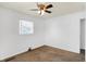 Neutral bedroom with a ceiling fan, a window with blinds, and brown carpet flooring at 143 Sawmill Rd, Whiteland, IN 46184