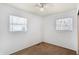 Bedroom featuring neutral carpet, two large windows, and plenty of natural light at 143 Sawmill Rd, Whiteland, IN 46184