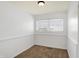 Bright bedroom features neutral carpet, a ceiling fan, and a window with blinds at 143 Sawmill Rd, Whiteland, IN 46184