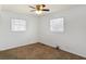 Bright bedroom features neutral carpet and two windows with blinds at 143 Sawmill Rd, Whiteland, IN 46184