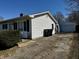 Exterior angle view of the home with detached garage, showing a well maintained lawn and curb appeal at 143 Sawmill Rd, Whiteland, IN 46184