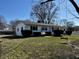 Attractive ranch home featuring a charming swing, manicured bushes, and a well-maintained front lawn at 143 Sawmill Rd, Whiteland, IN 46184