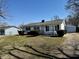 Quaint home exterior highlighting the tidy front yard, detached garage, and well-maintained landscape at 143 Sawmill Rd, Whiteland, IN 46184