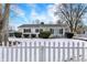 Charming single-story home with a picket fence and snowy front yard at 143 Sawmill Rd, Whiteland, IN 46184