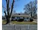 Charming single-story home featuring a classic white picket fence and a well-manicured front lawn on a sunny day at 143 Sawmill Rd, Whiteland, IN 46184