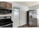 The kitchen area features stainless appliances including a built in microwave and refrigerator at 143 Sawmill Rd, Whiteland, IN 46184