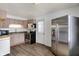 Cozy kitchen with stainless steel refrigerator, laminate counters and black appliances at 143 Sawmill Rd, Whiteland, IN 46184