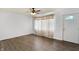 A bright living room with modern wood floors, a ceiling fan, and a front door at 143 Sawmill Rd, Whiteland, IN 46184