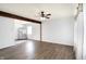 Open concept living room with wood floors and stainless steel refrigerator at 143 Sawmill Rd, Whiteland, IN 46184