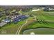 Panoramic aerial view of a golf course community, featuring a clubhouse, ponds, and lush green fairways, offering a resort-style experience at 16473 Valhalla Dr, Noblesville, IN 46060