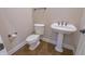 This bathroom features classic fixtures including a pedestal sink and a toilet at 1655 Rosebud Ln, Greenwood, IN 46143