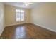 Bedroom with hardwood flooring, base trim, ceiling fan, and natural light at 1655 Rosebud Ln, Greenwood, IN 46143