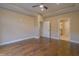Spacious bedroom featuring gleaming hardwood floors and multiple door openings at 1655 Rosebud Ln, Greenwood, IN 46143