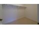 Walk-in closet features carpet and shelving for ample storage space and organization at 1655 Rosebud Ln, Greenwood, IN 46143