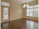 Dining room with hardwood flooring, chandelier, and natural light at 1655 Rosebud Ln, Greenwood, IN 46143