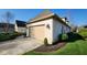Attractive home featuring a beige garage door, well-maintained greenery, and a clean driveway at 1655 Rosebud Ln, Greenwood, IN 46143