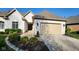 Charming white brick home with a well-manicured lawn and a beige garage door on a sunny day at 1655 Rosebud Ln, Greenwood, IN 46143