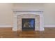 Elegant fireplace with stone surround and custom mantel on hardwood floor at 1655 Rosebud Ln, Greenwood, IN 46143