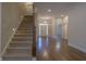 Spacious home foyer with a staircase, hardwood floors, chandelier, and a view of the front door at 1655 Rosebud Ln, Greenwood, IN 46143
