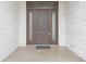 Elegant wood front door with sidelights, set in a white brick surround at 1655 Rosebud Ln, Greenwood, IN 46143
